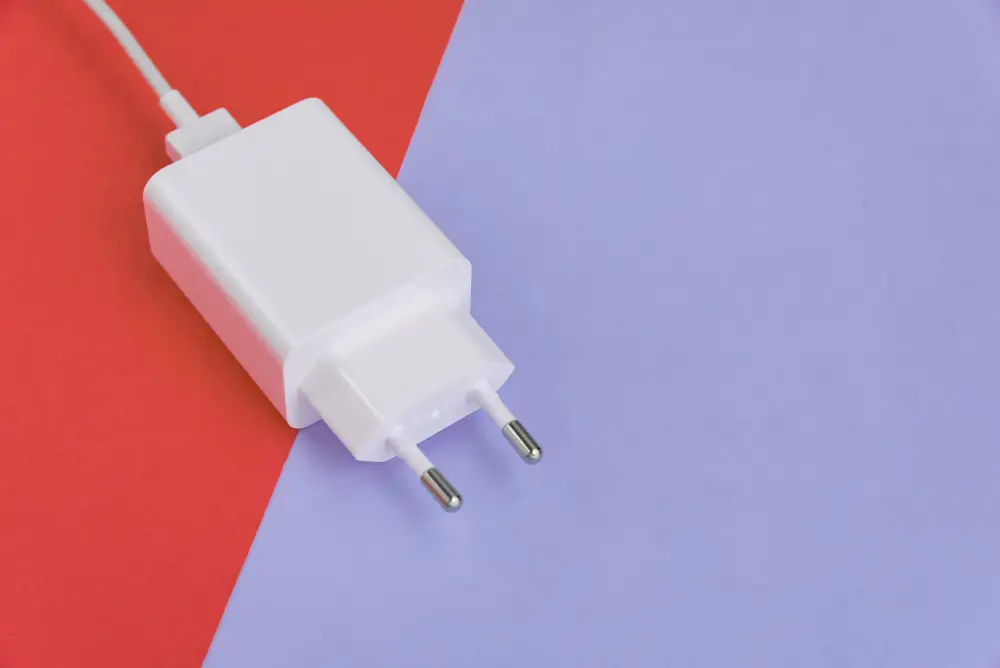 charger-and-usb-cable-over-pink-and-blue-background