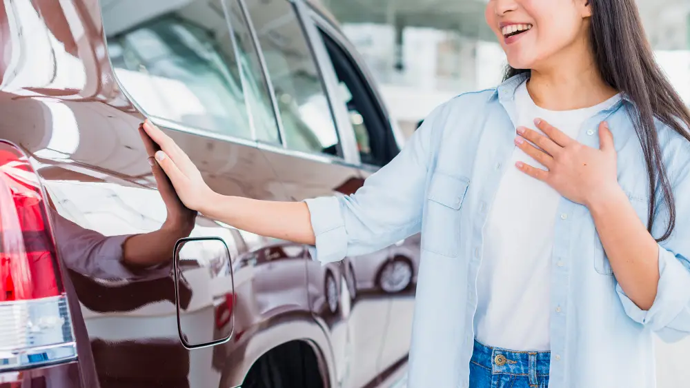 happy-woman-in-car-dealership