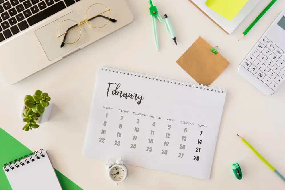 top-view-desk-calendar-and-cute-indoors-plant