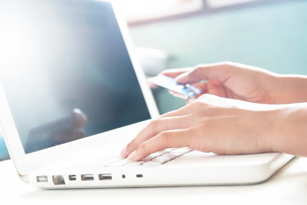 woman-hands-on-keyboard-of-laptop-and-holding-credit-card